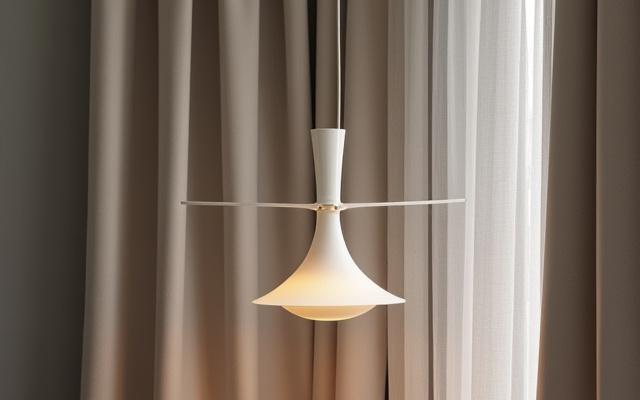 An elegant, modern lighting fixture with luxurious curtain fabric